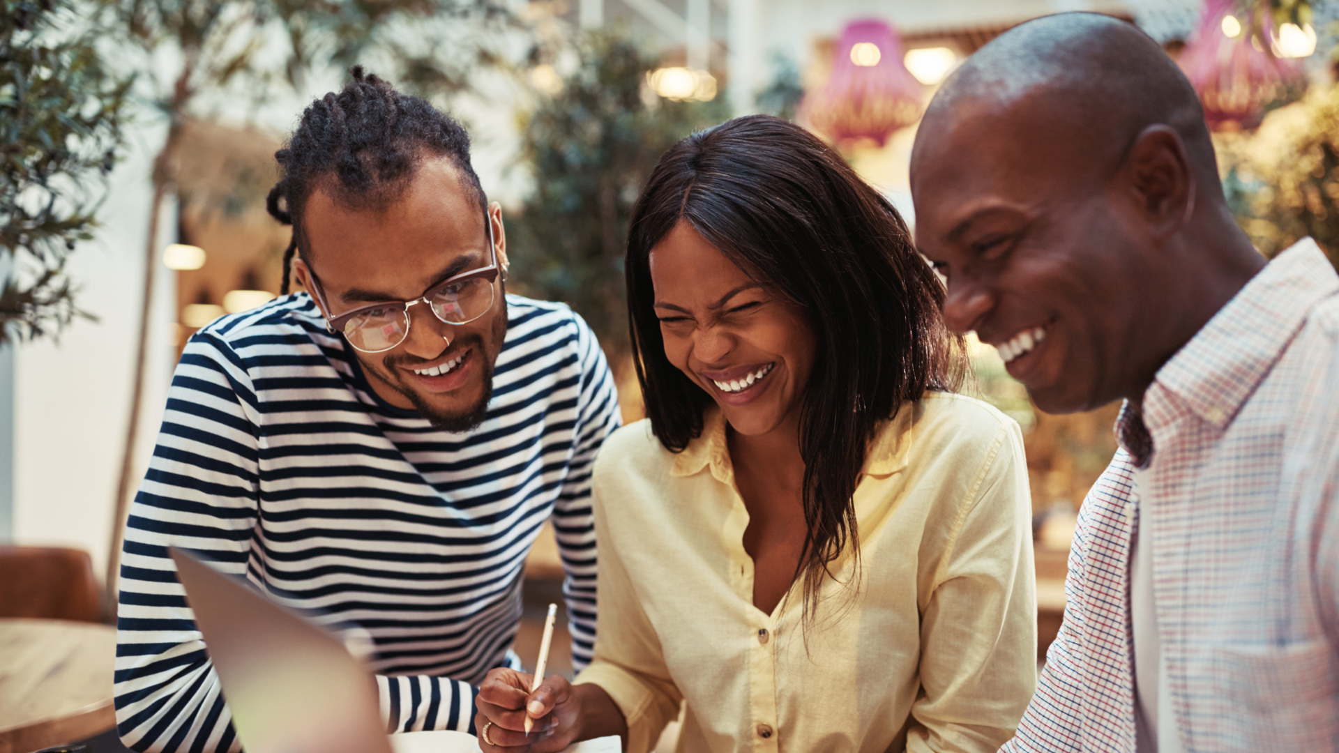 Three African American people going over business ideas 